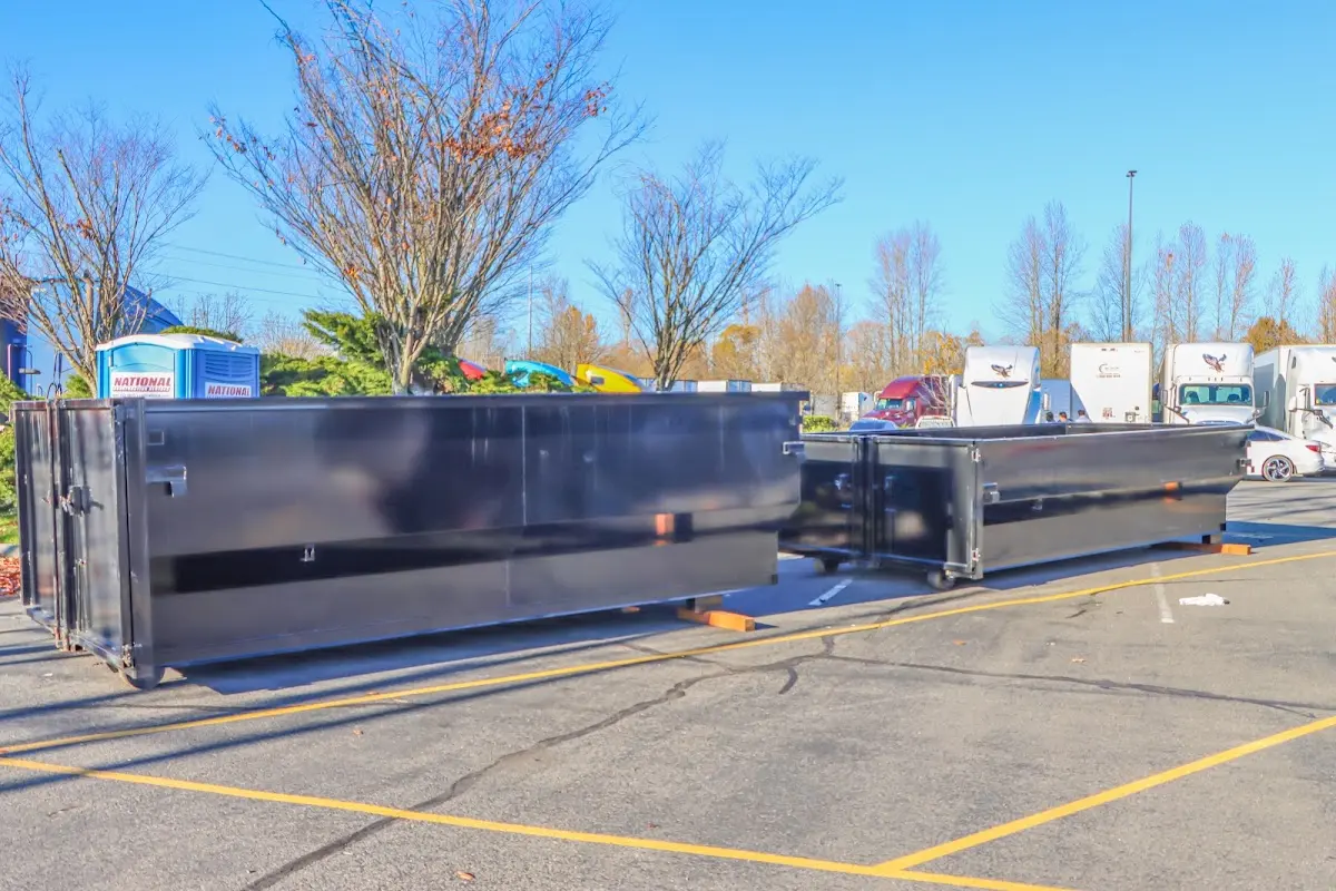 Professional dumpster rental service with roll-off container on residential driveway in Hillsboro